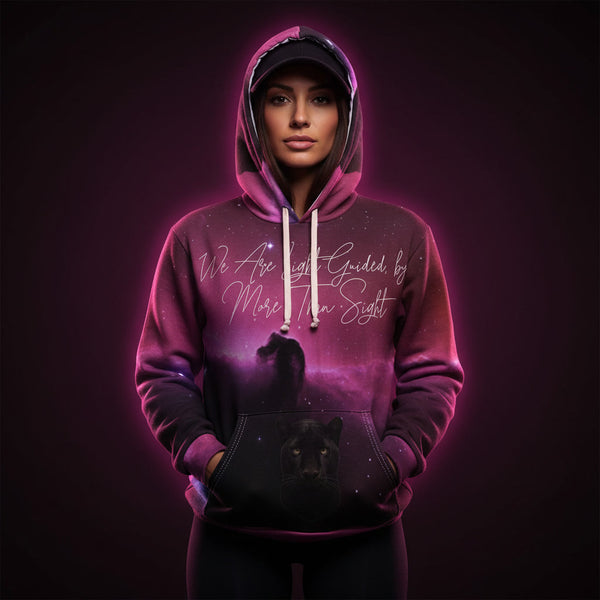 Person wearing a pink hoodie with a wolf design and text on a dark background