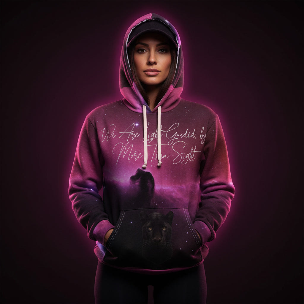Person wearing a pink hoodie with a wolf design and text on a dark background